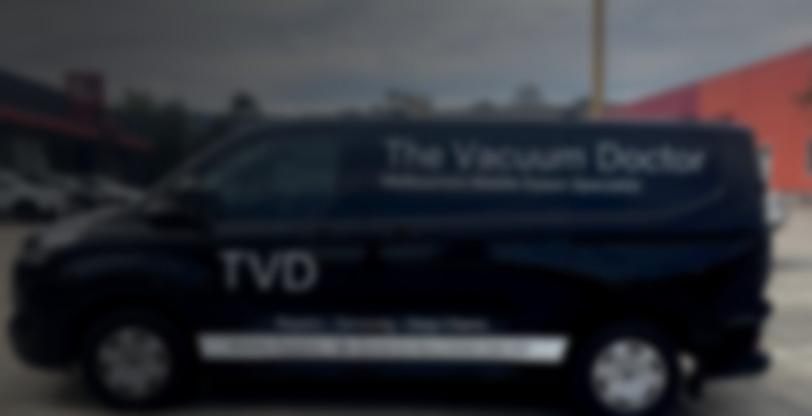 The Vacuum Doctor mobile Dyson repair van, a black Ford Transit with TVD branding, in Melbourne