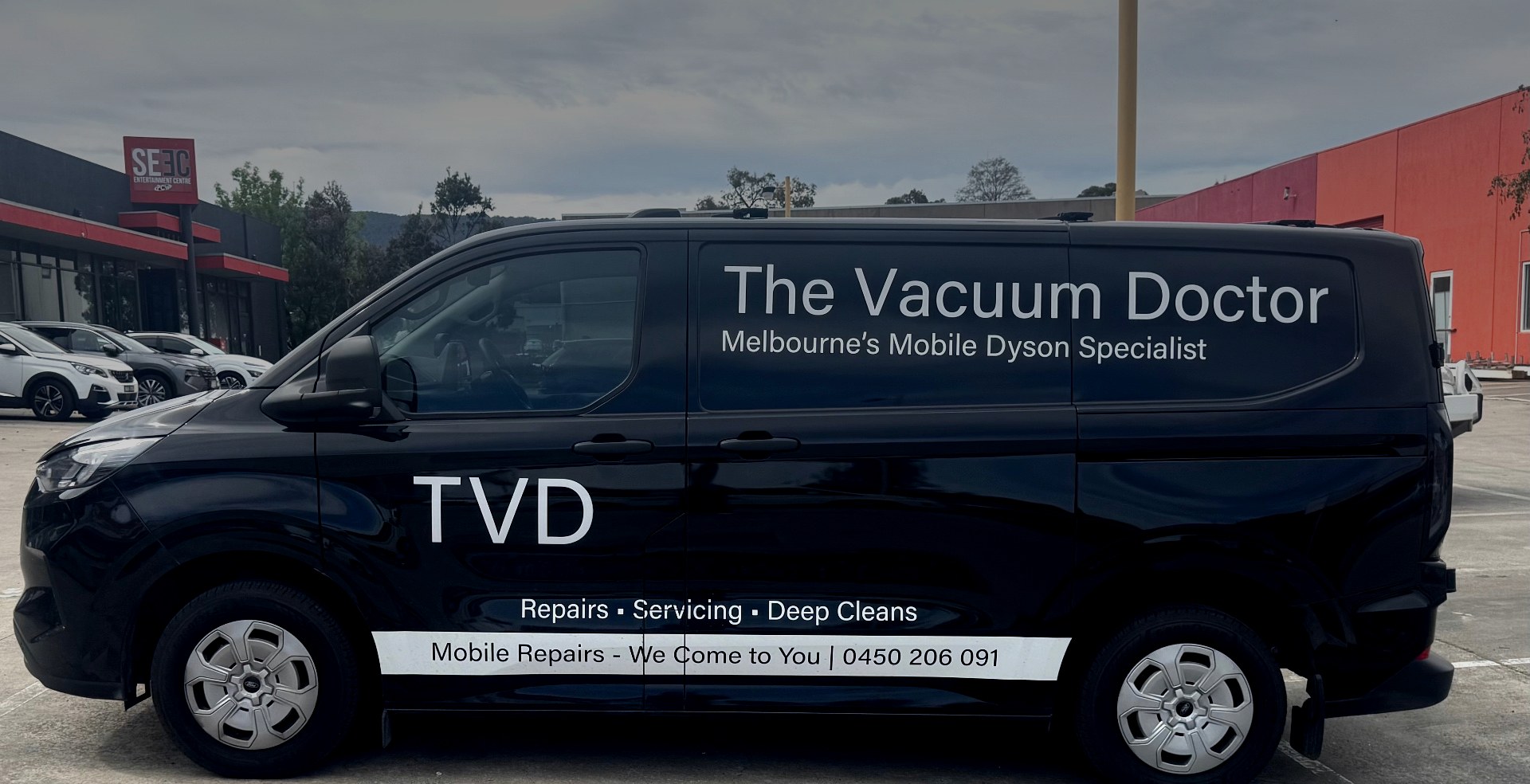 The Vacuum Doctor mobile Dyson repair van, a black Ford Transit with TVD branding